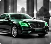Black luxury sedan with green headlights parked in the city